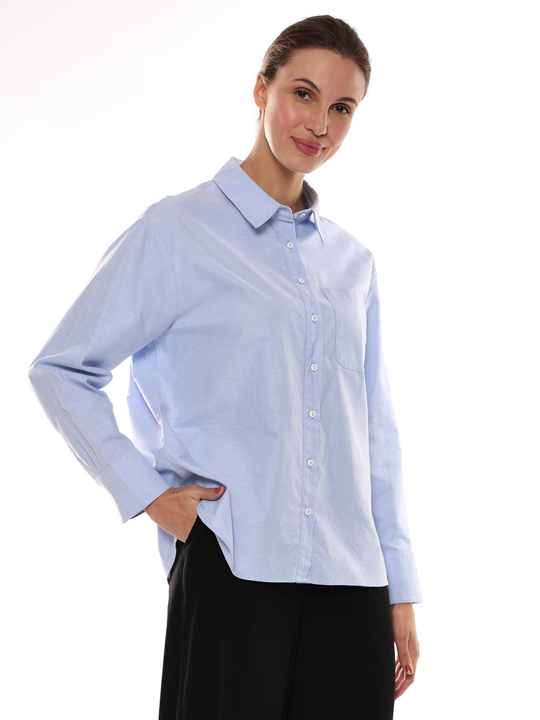 Girl wearing solid sky blue cotton oxford women's shirt from Gazillion