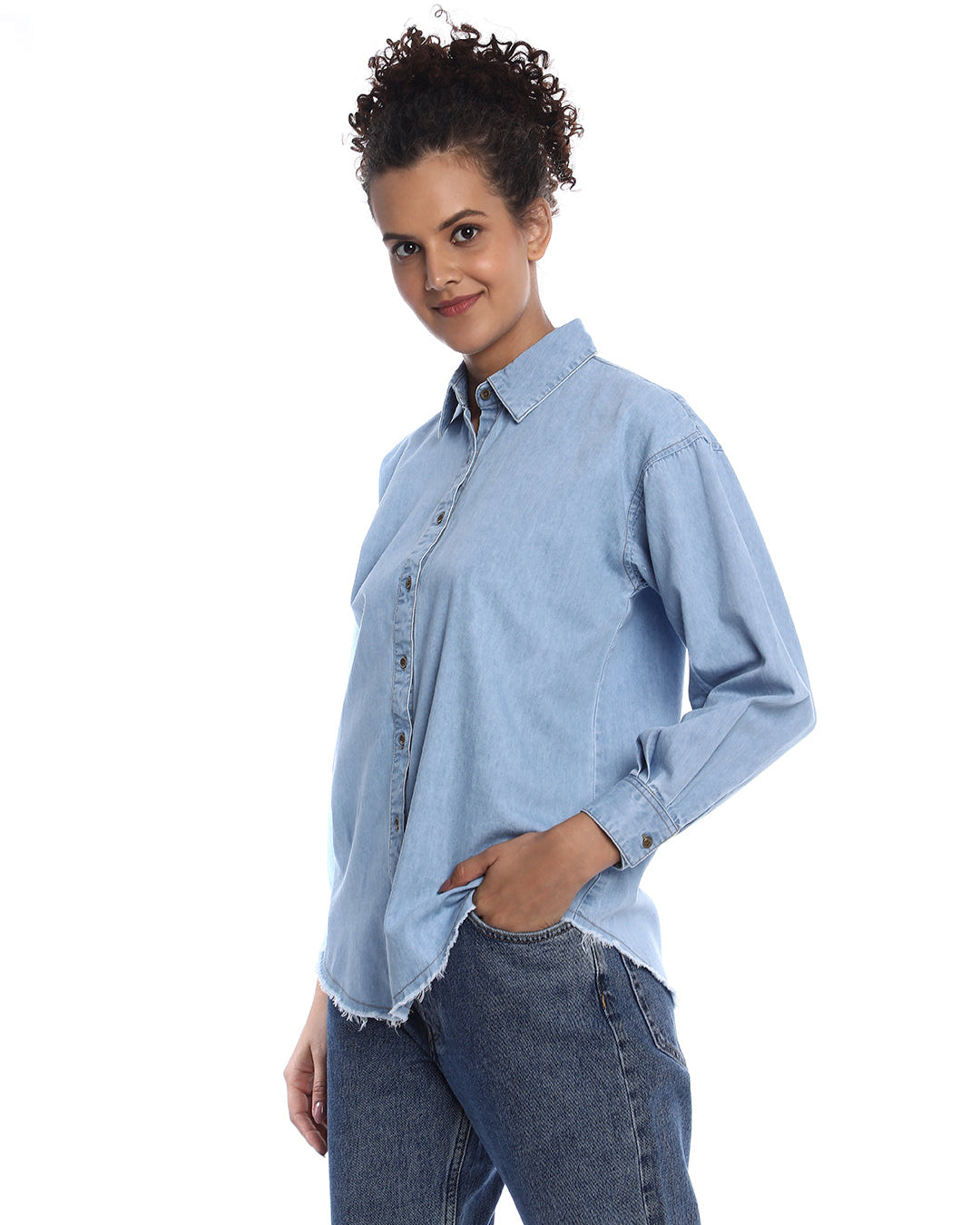 A Woman walking in an Oversized Denim Shirt from Gazillion paired with skinny jeans