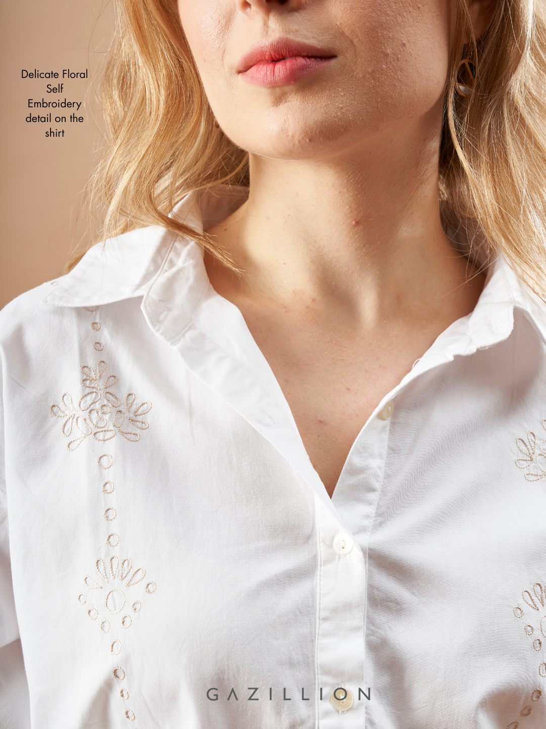 White shirt with floral embroidery detail, brand 'Gazillion' visible