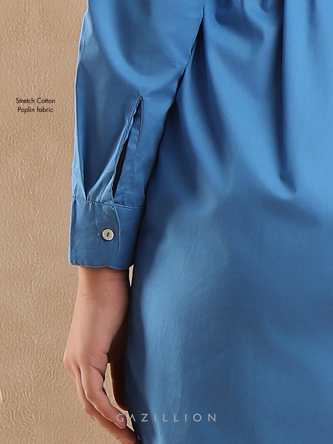 Blue shirt with rolled-up sleeve on a beige background