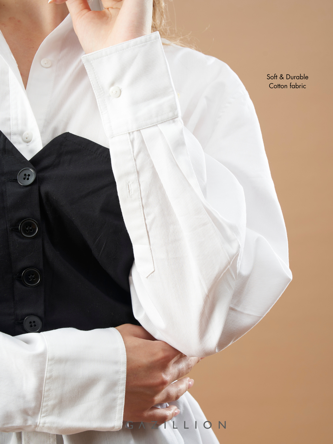 White shirt with black vest on a beige background
