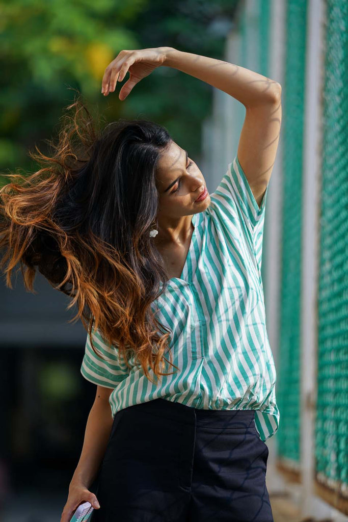 A Woman playing with her beautiful hair wearing a Green & White Striped Viscose Shirt from Gazillion