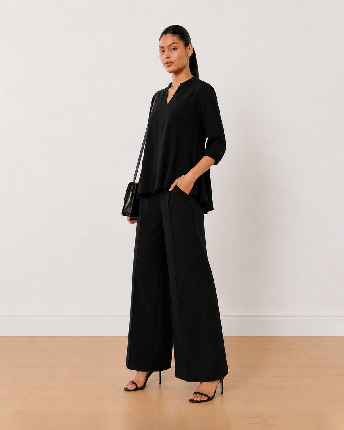 Alda black 100% viscose loose top, angled front view with the boxy fit