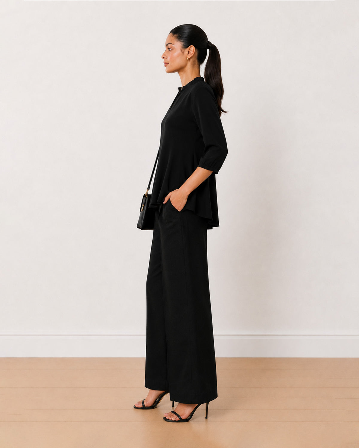 Alda black viscose loose top side profile with the extended shoulders