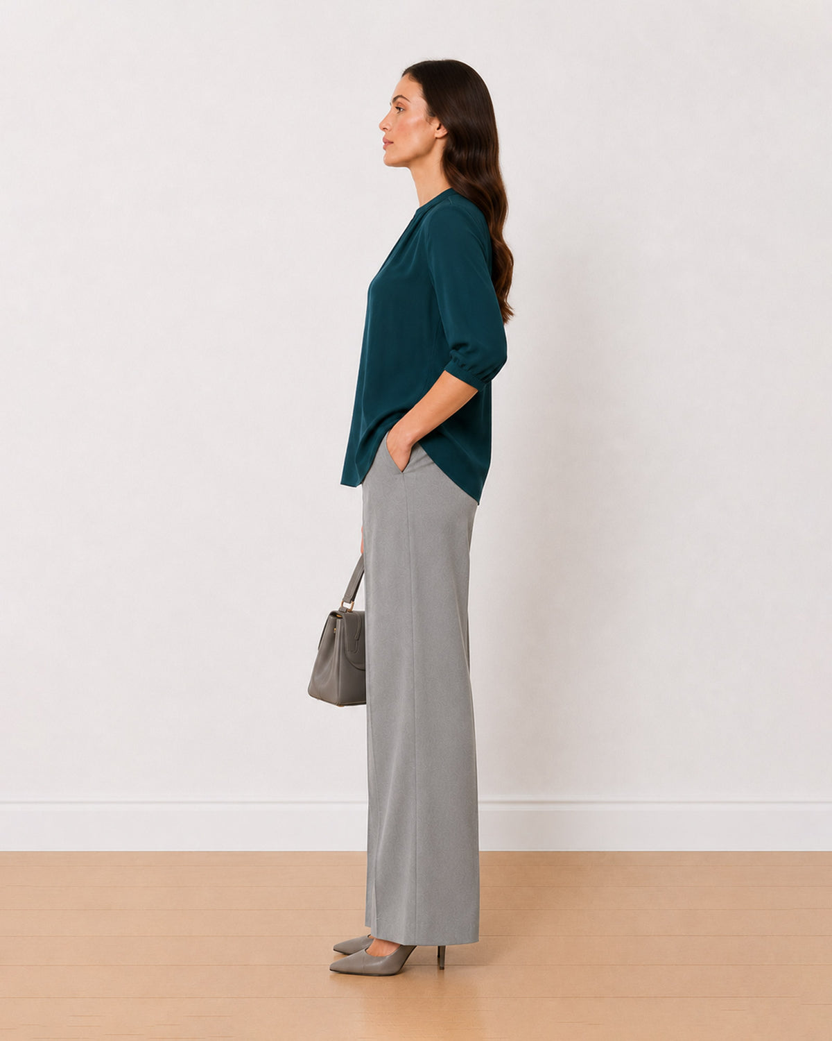 Alda bottle green viscose loose top side profile with the long curved hem