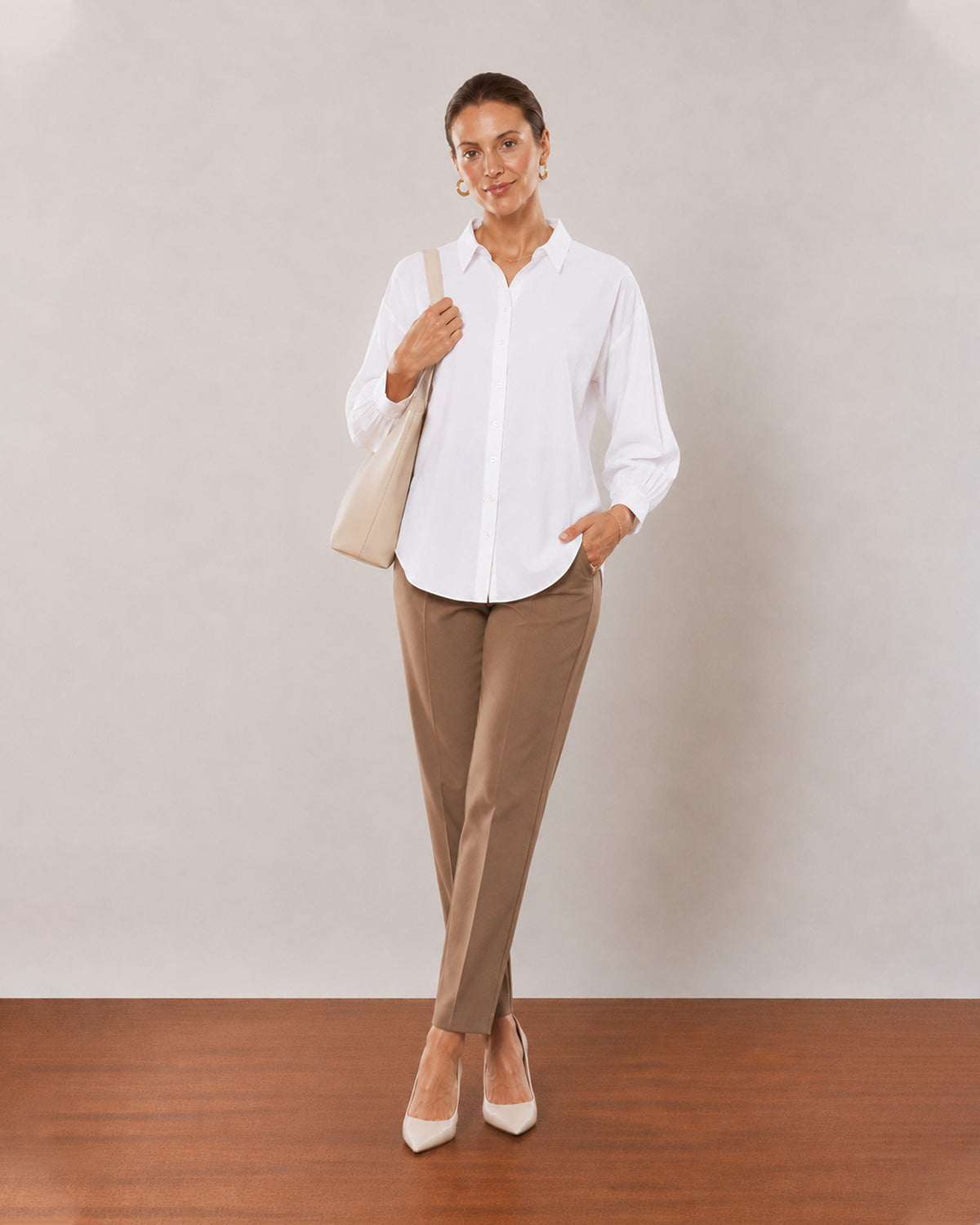 Alexis white cotton linen shirt on the move, front view with the long curved hem
