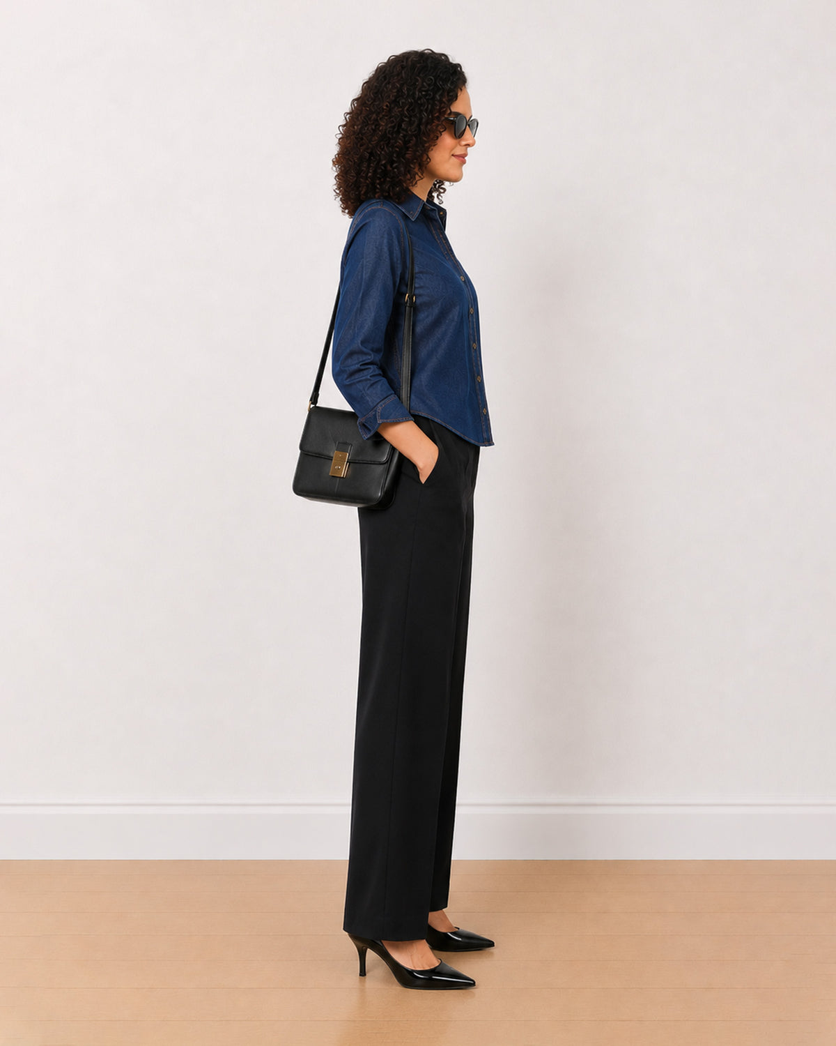 Banita medium blue denim shirt side view with the long length and curved hem