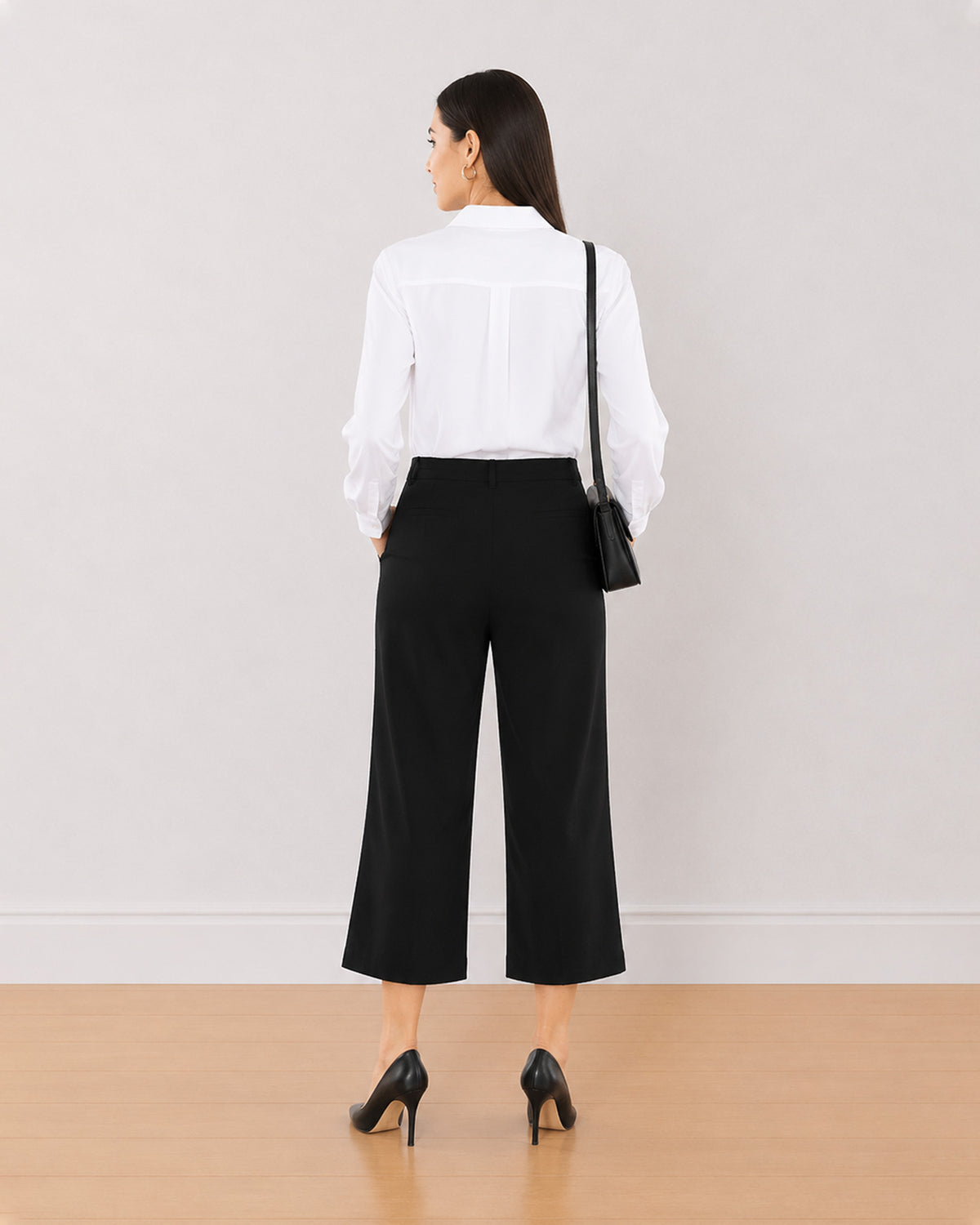 Bella black 3/4th straight pants back view with the medium waist and straight leg