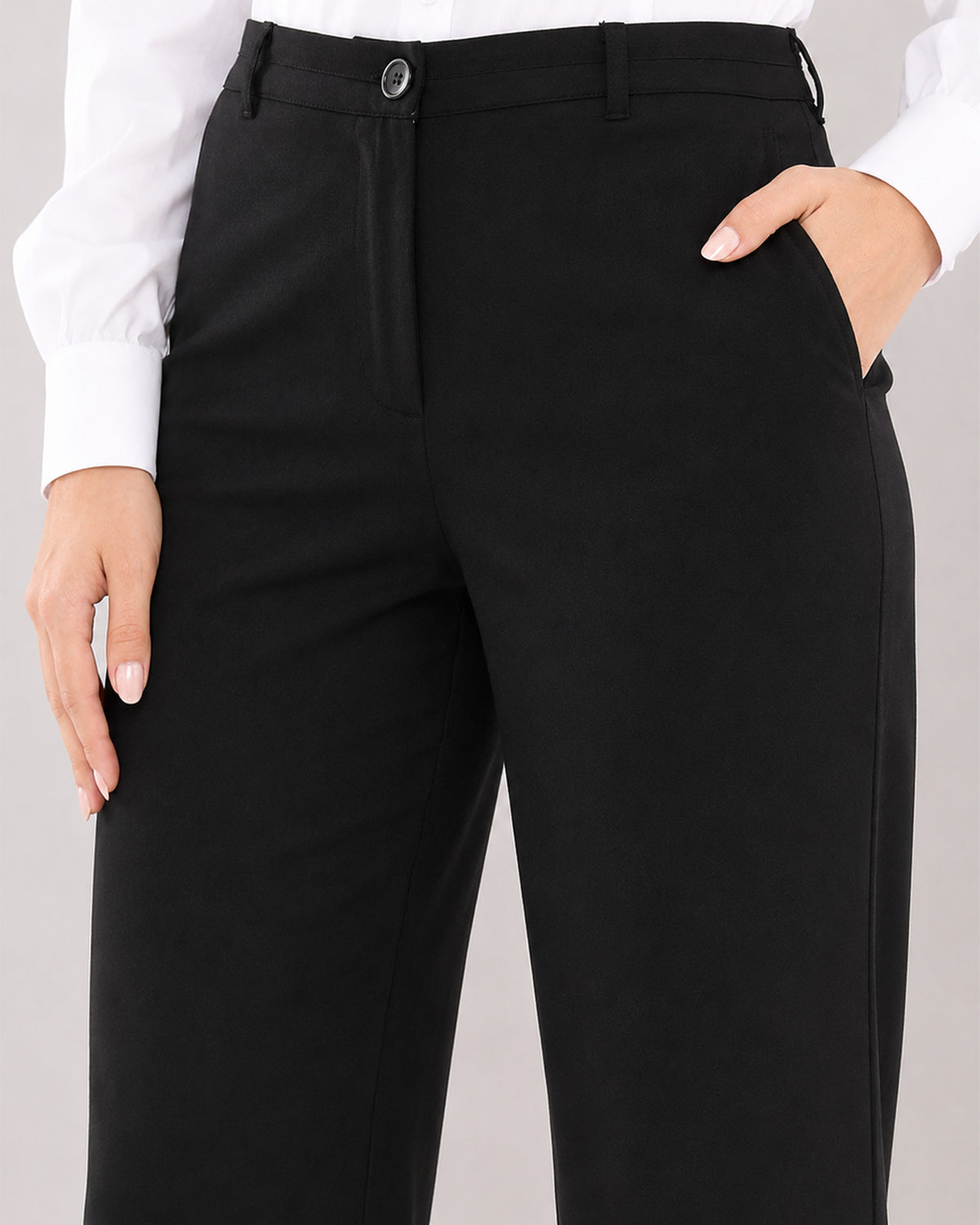 Bella black pants waistband close-up with button and zip opening and side cross pocket