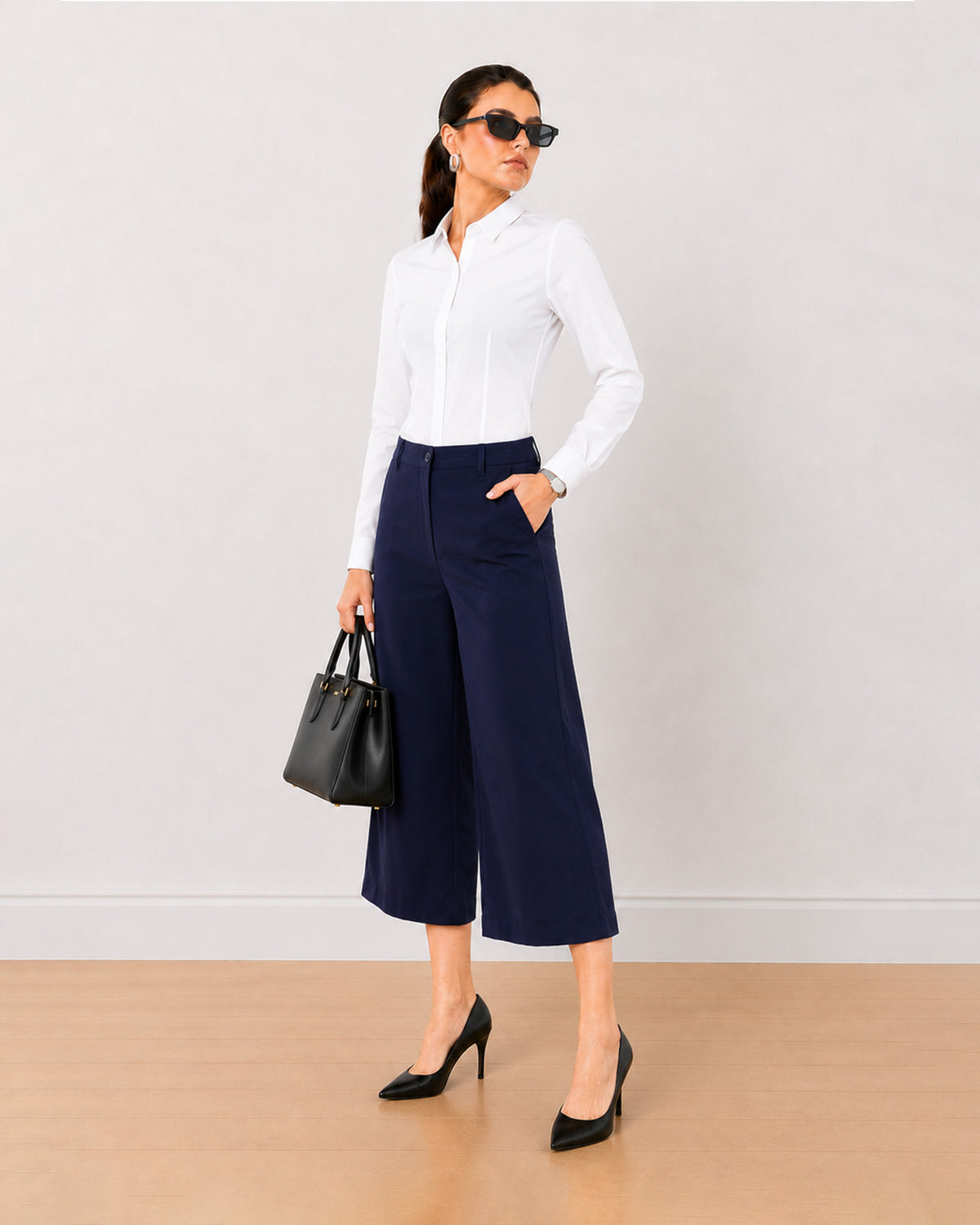 Bella navy blue loose fit 3/4th straight pants, angled front view in mid calf length