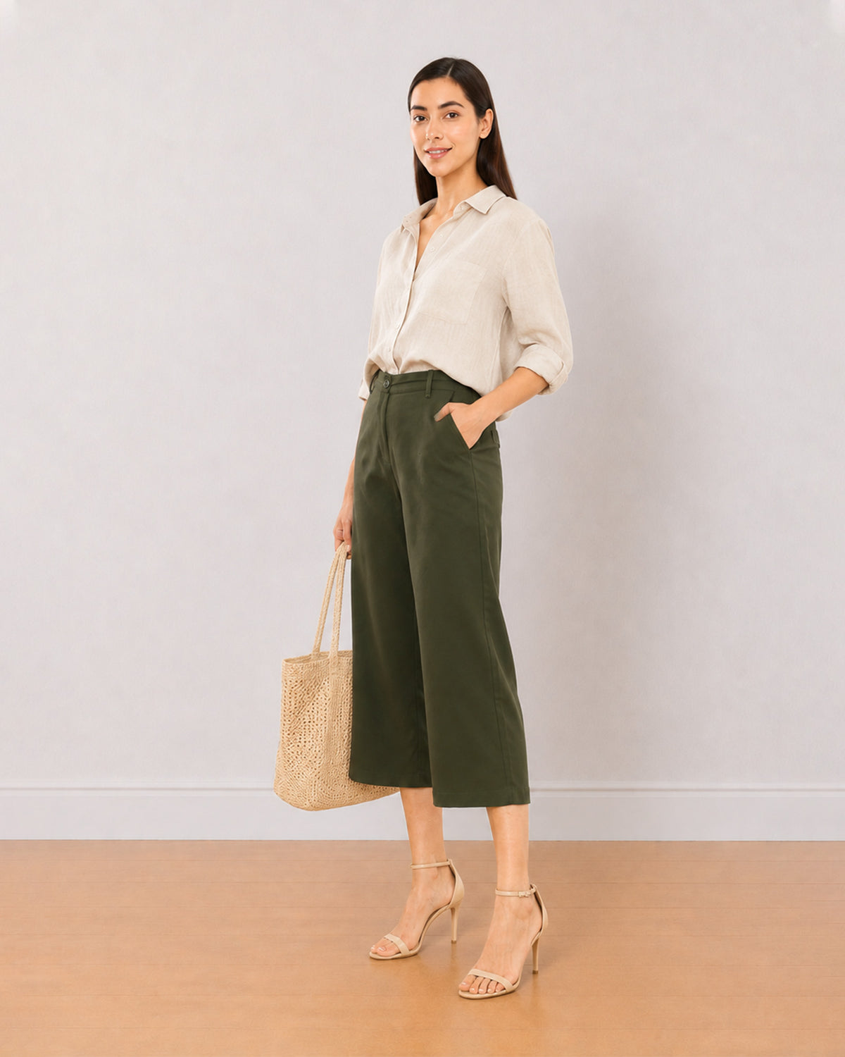Bella olive green 3/4th straight pants front view with a hand in the side cross pocket