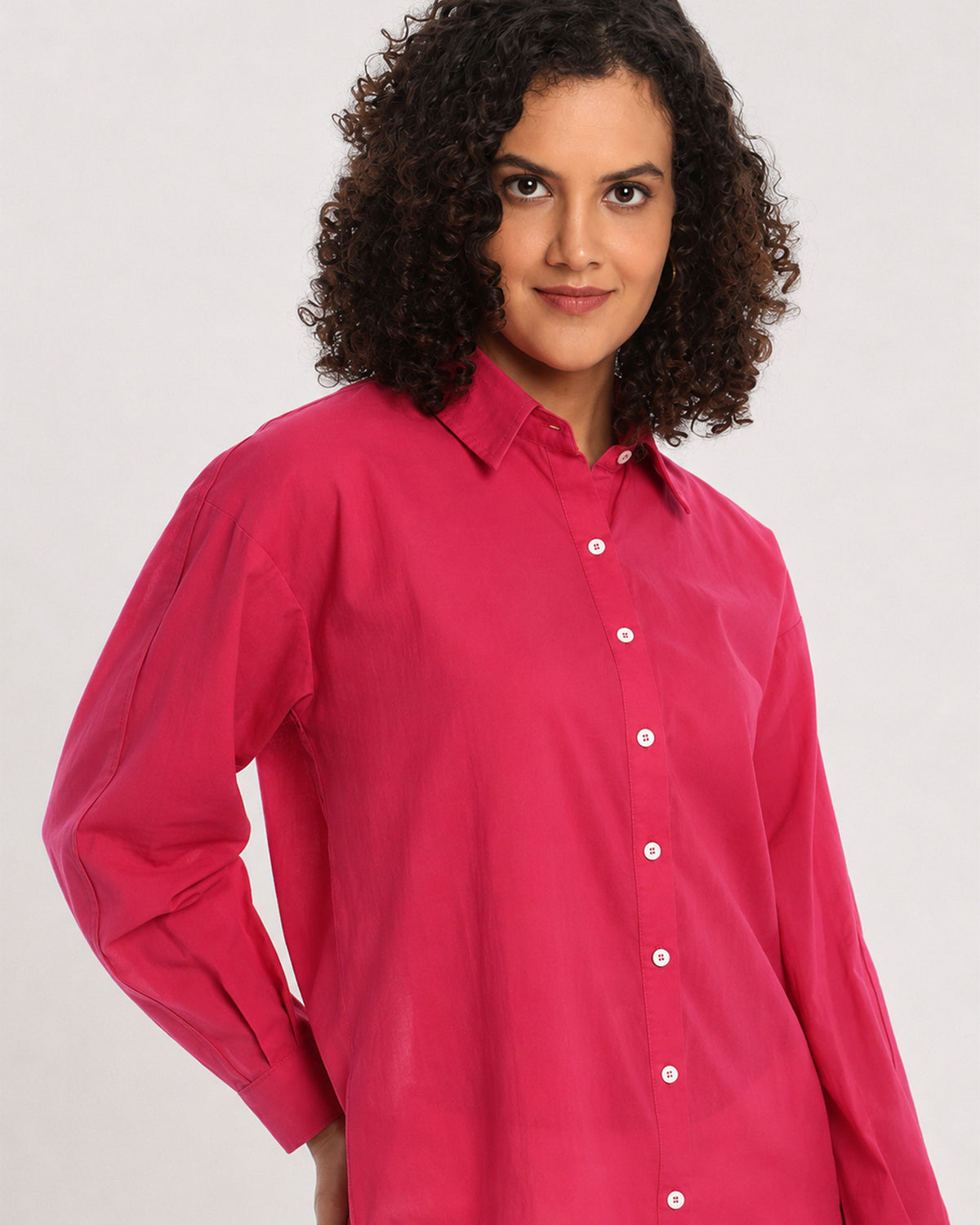 Berry bright pink shirt, angled waist up view with the drop shoulder and full sleeves