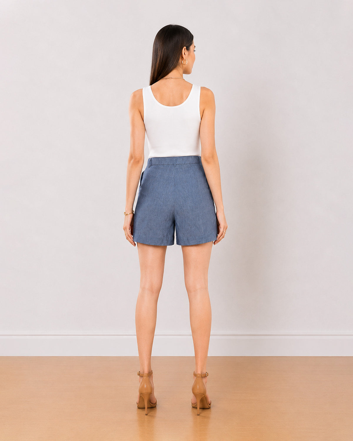 Blair denim blue high waisted summer shorts back view with the mid thigh hem