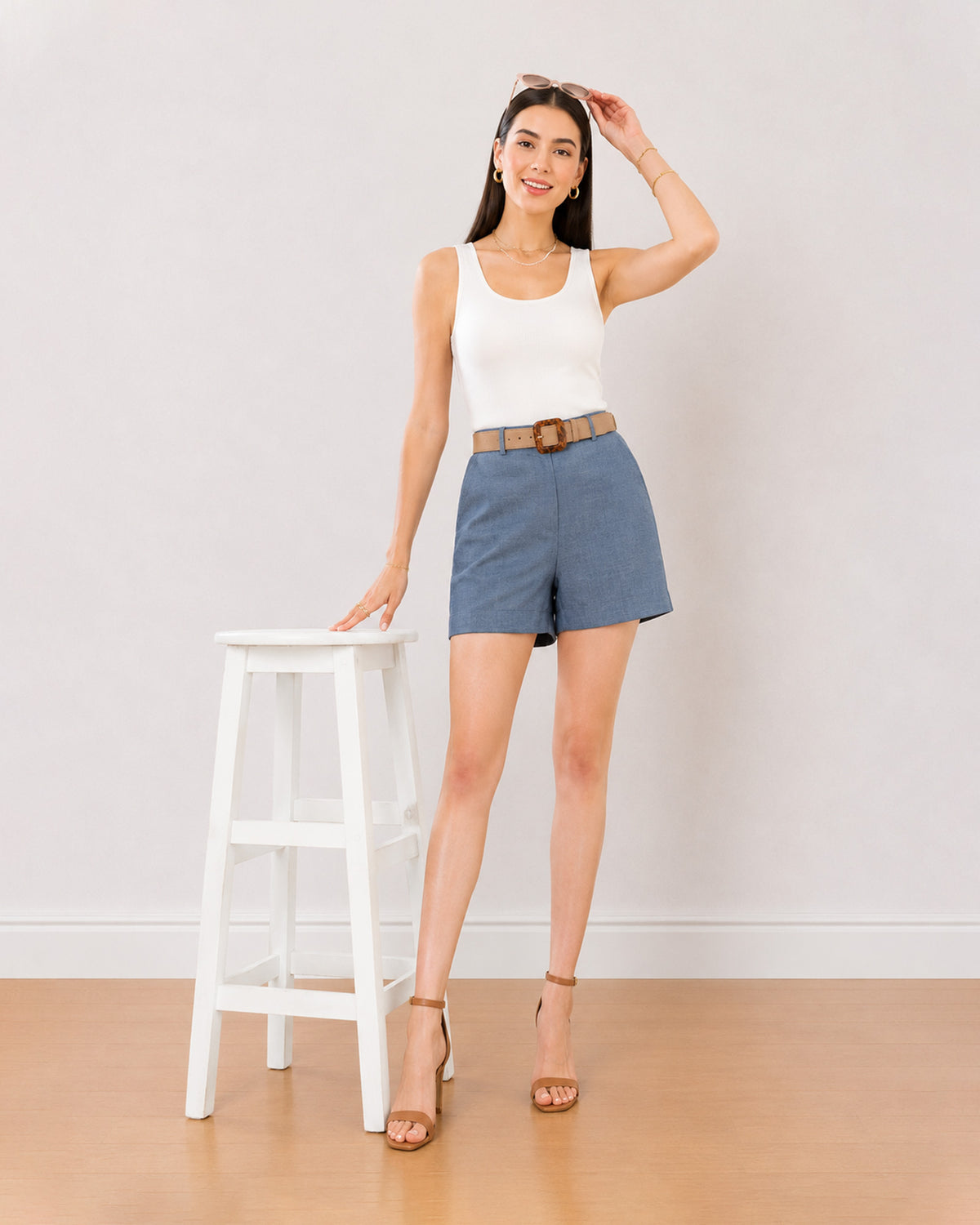 Blair denim blue high waisted summer shorts worn loose, front view at mid thigh