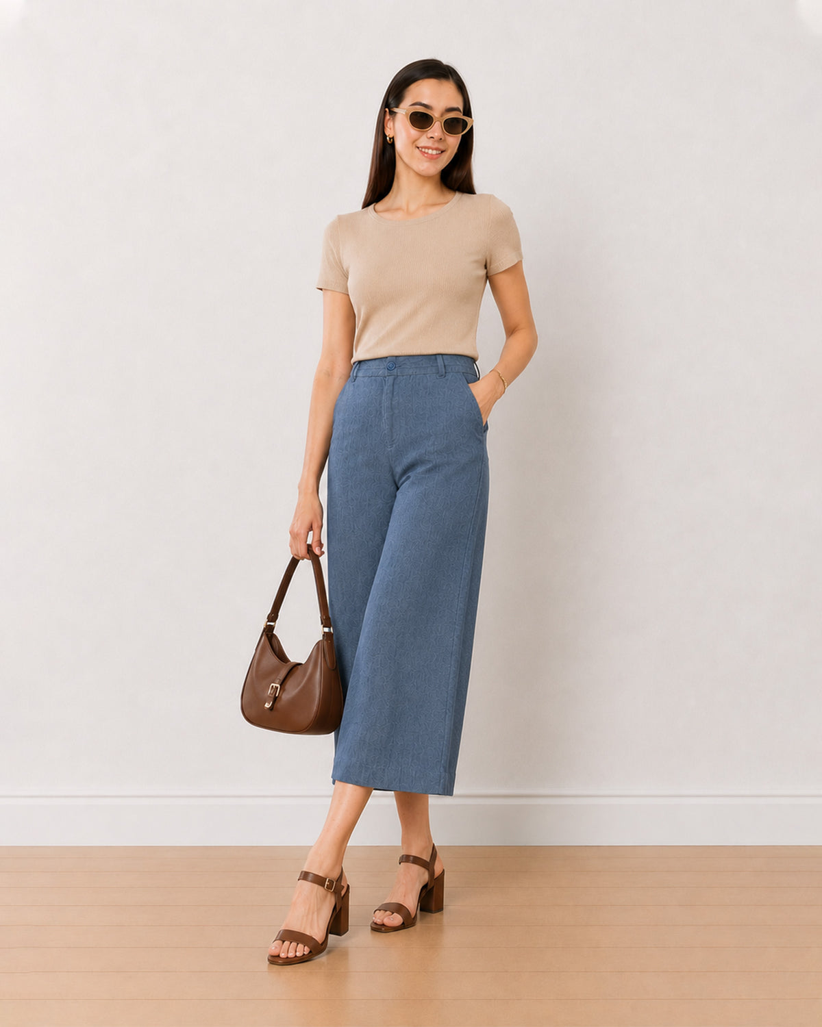 Bliss denim blue high waisted 3/4th straight pants, angled front view of the loose fit