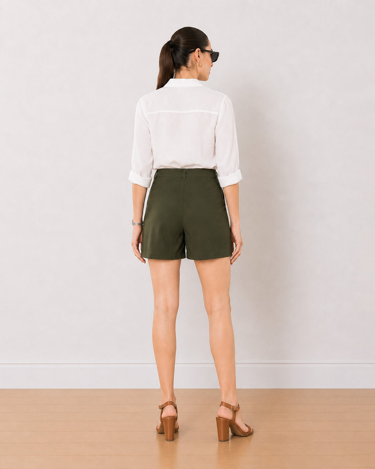 Bobby olive green summer shorts back view walking, mid thigh length and loose fit