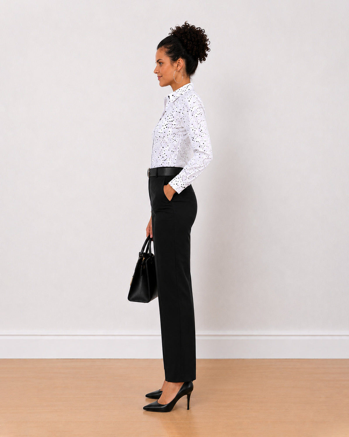 Brenda black and white polka dots shirt side view with the long curved hem
