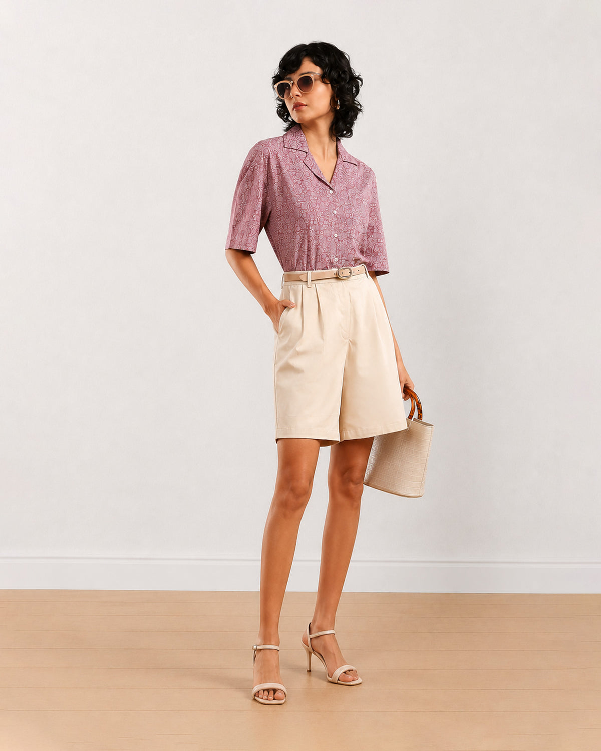 Celine beige poly cotton shorts front view with hand in the side cross pocket