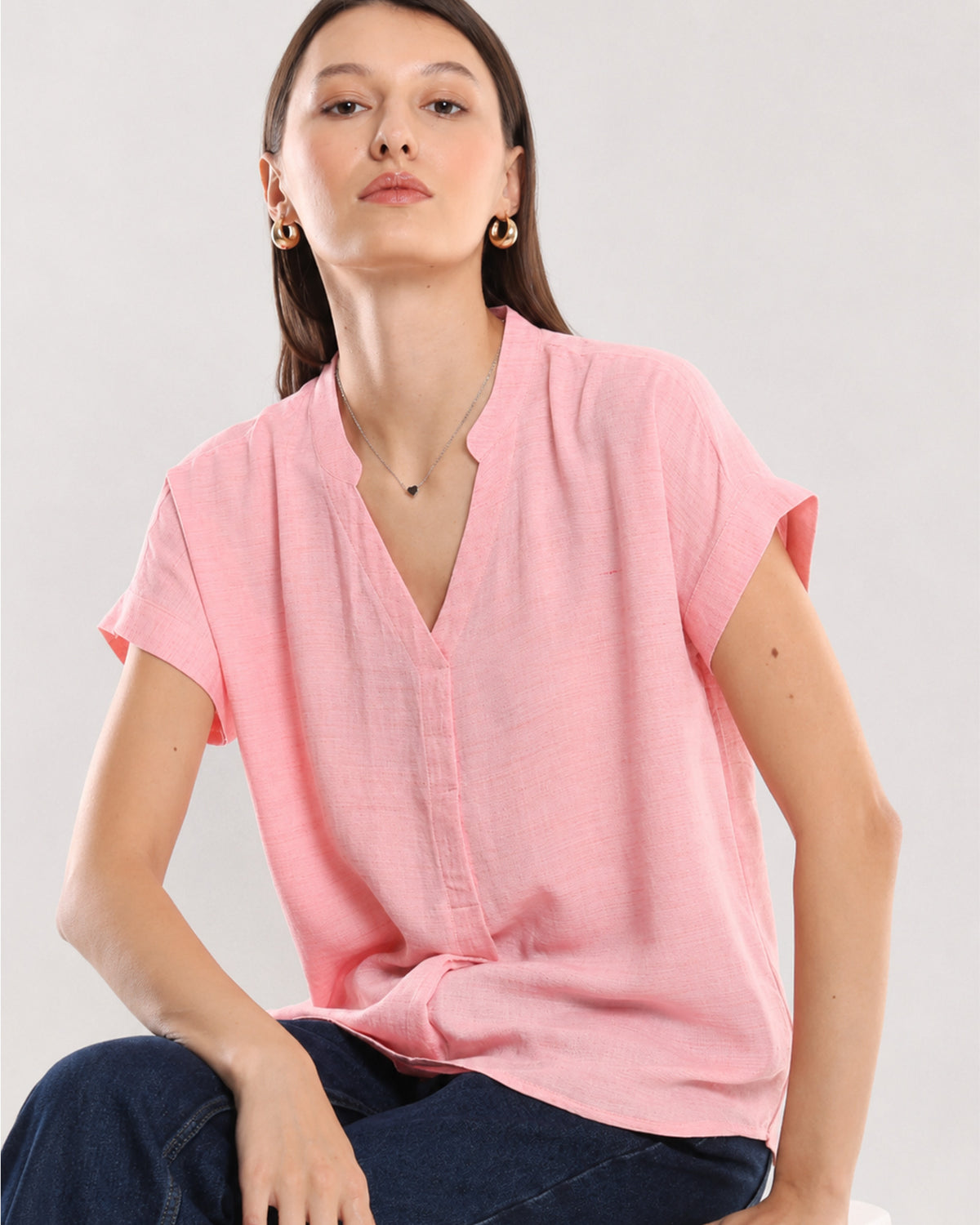 Chloe pink 100% rayon formal top seated view with stand collar and extended shoulders