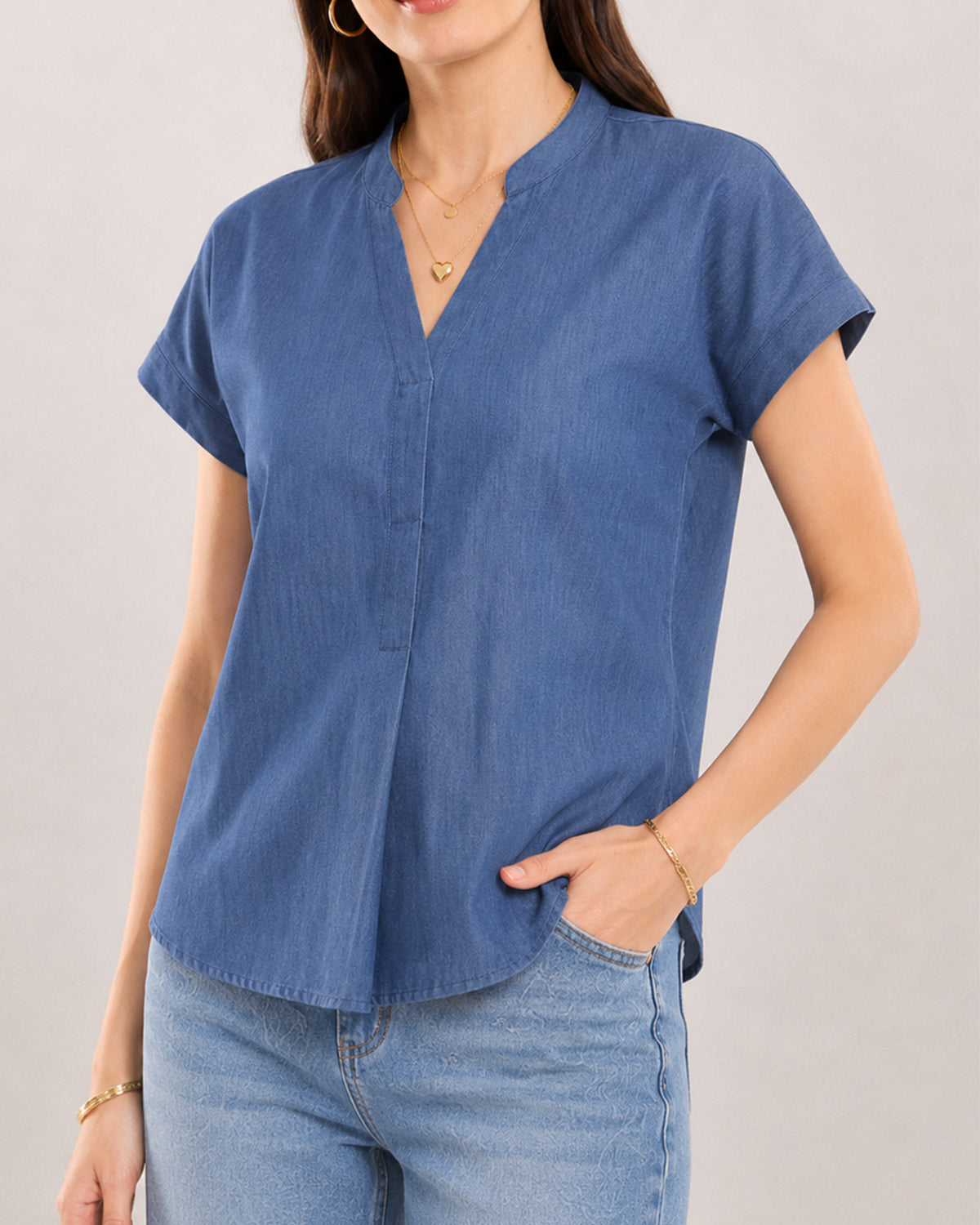 Close-up of Cora indigo blue top stand collar with V-neck and centre front pleat