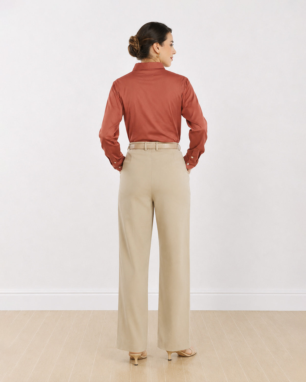 Dame terracotta brown formal shirt, back view showing the back waist darts and buttoned cuffs