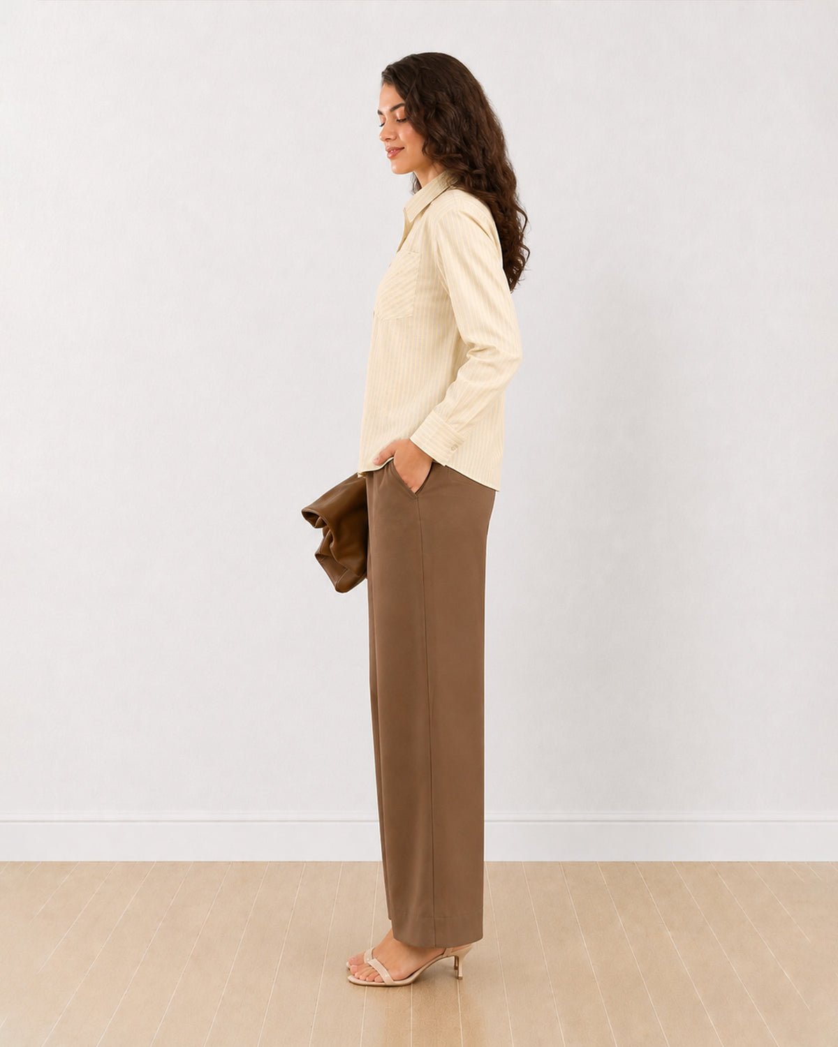 Delisa neon green striped oversized shirt, side profile view showing the long curved hem