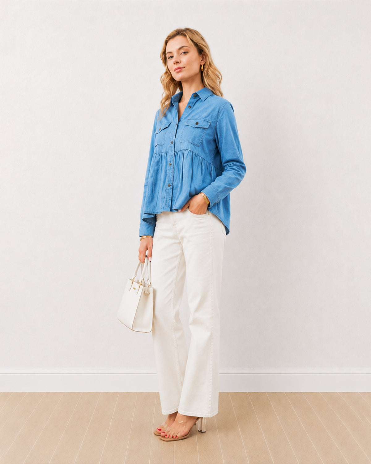 Delta light wash indigo blue denim peplum shirt, angled front view of the oversized fit