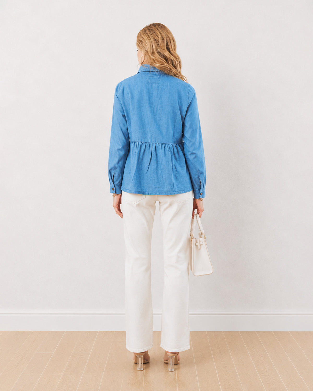 Delta light blue denim peplum shirt, back view of the long oversized length