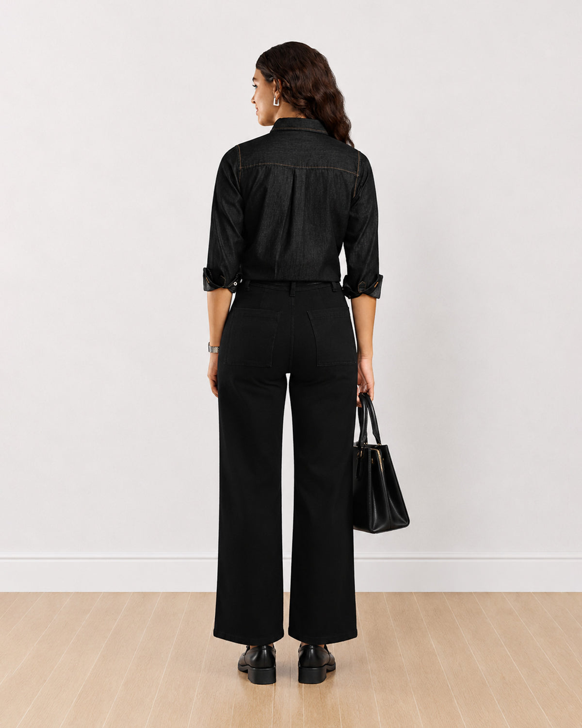 Desire black denim shirt, back view with sleeves rolled to the elbow
