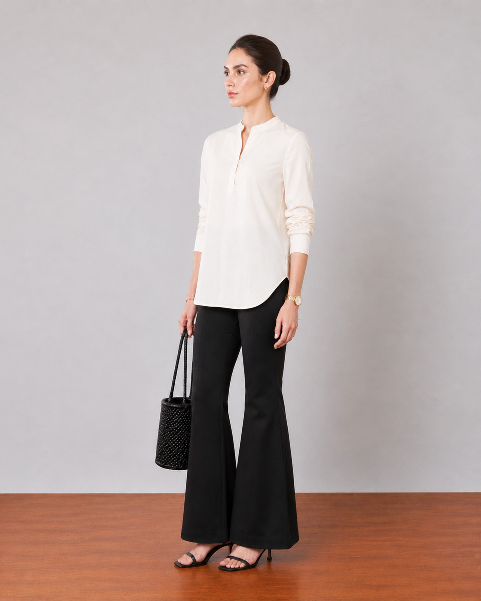 Gemini beige linen tunic top with shoulder pleats and a band collar, angled view