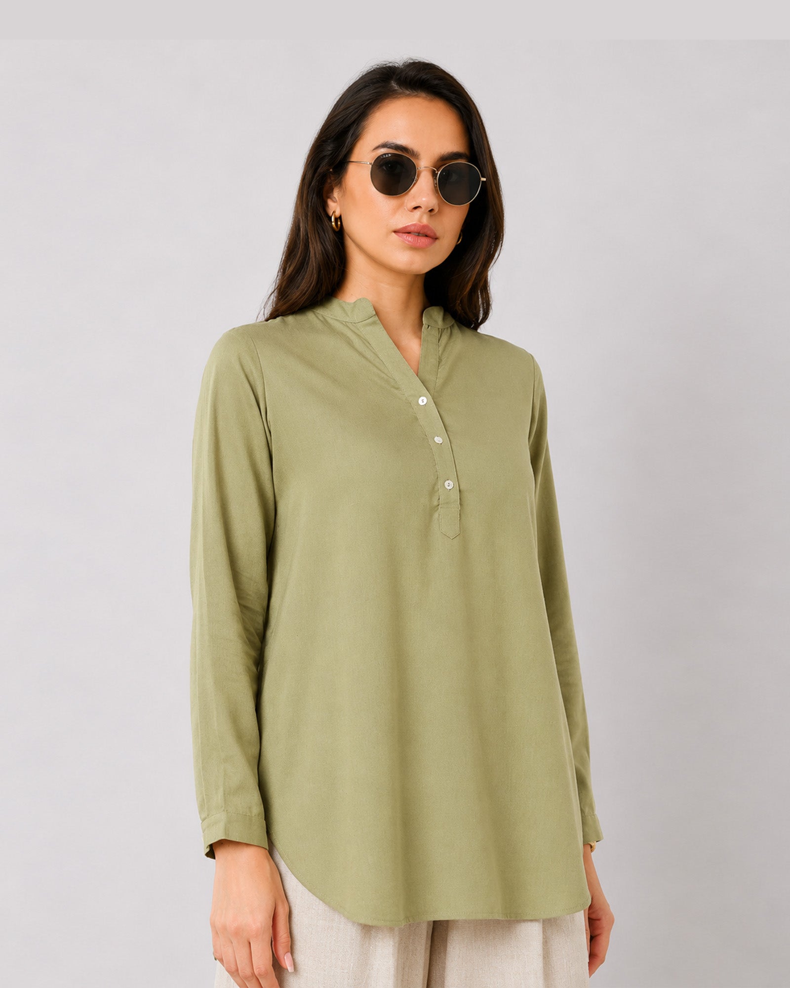 Gemini moss green linen tunic top with shoulder pleats and a button placket, front detail