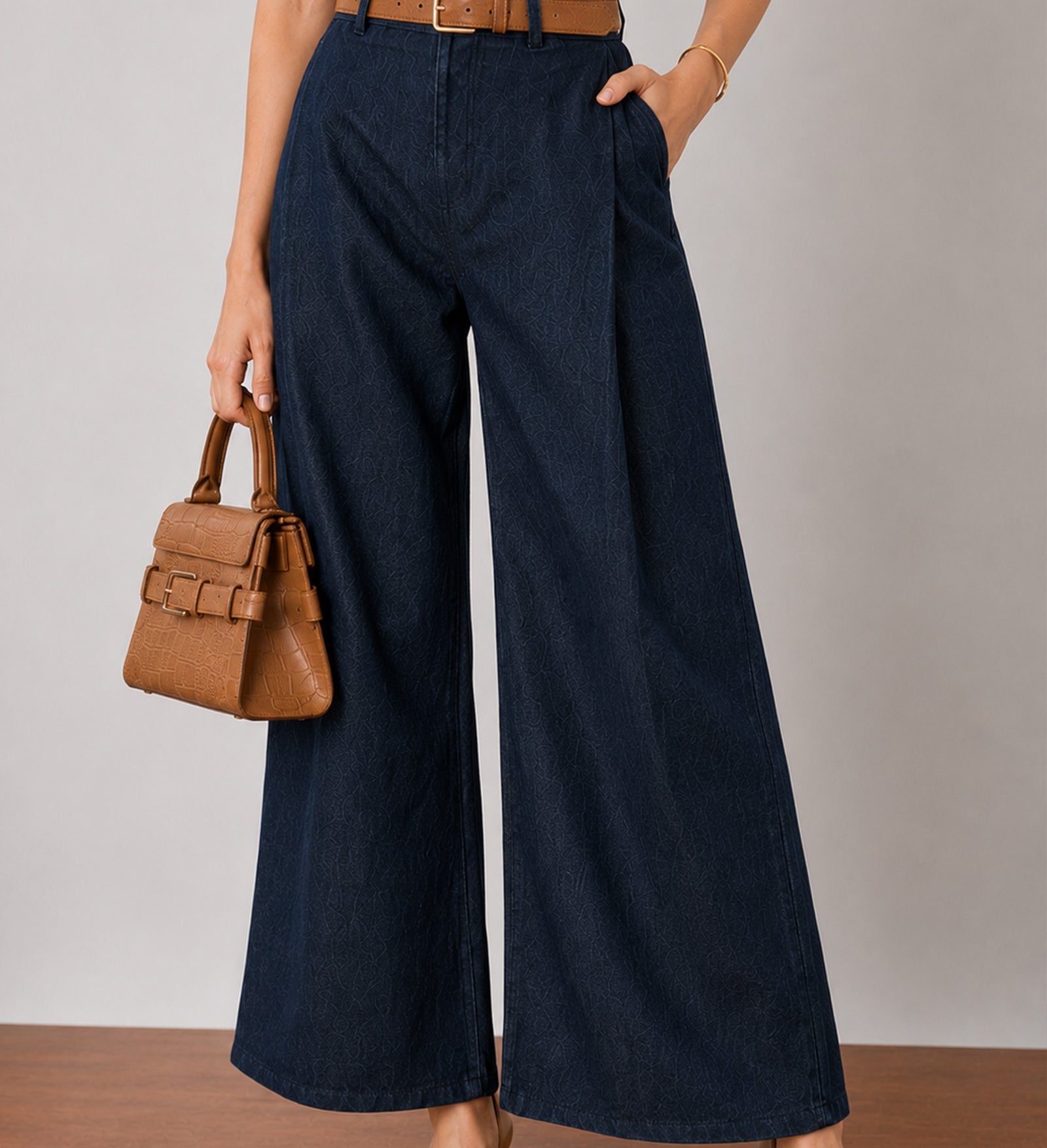 Close-up of Gigi indigo blue denim pants waistband and double front pleats