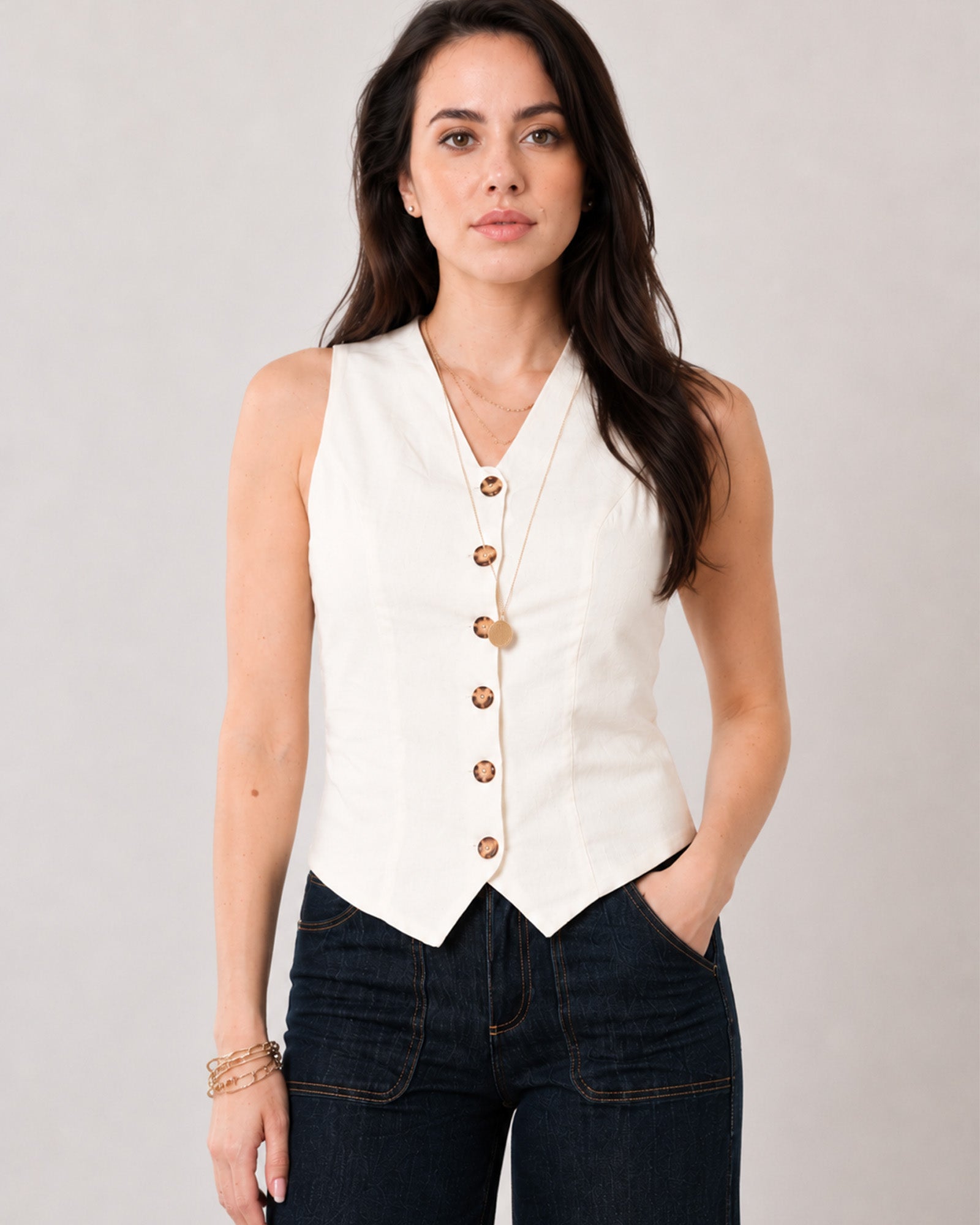 Ginger beige sleeveless linen vest with a V-neckline and pointed hem, angled view