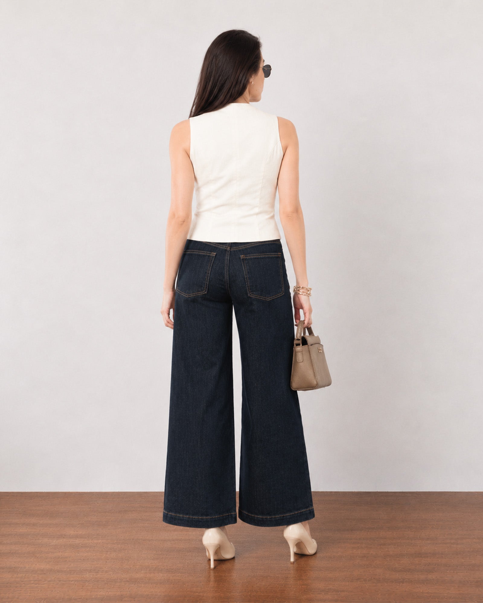 Ginger beige linen vest with cotton voile lining, back view showing the fitted panel seams and extended length