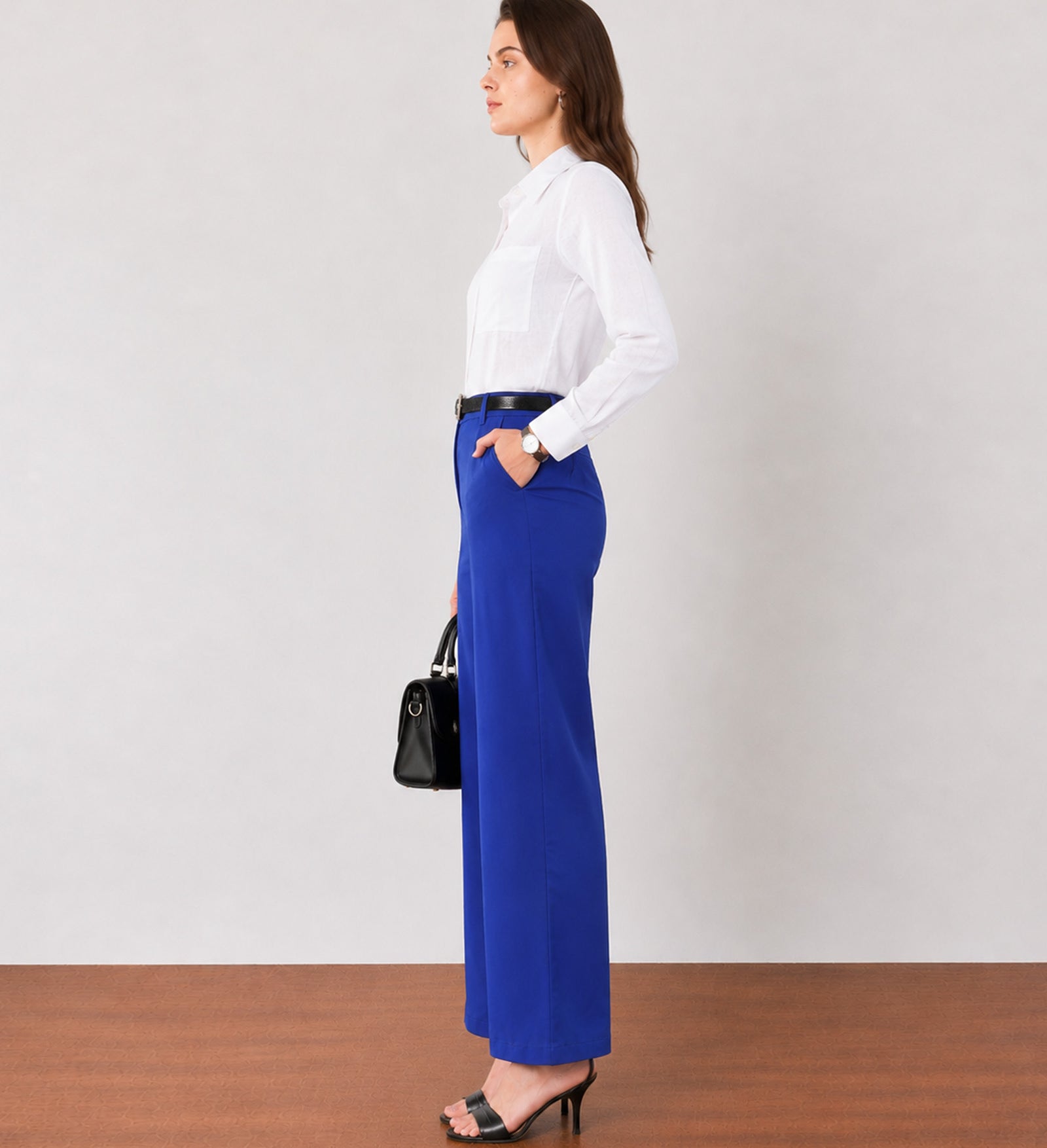 Glin royal blue cotton satin pants with structured front pleats, side profile showing the broad leg drape