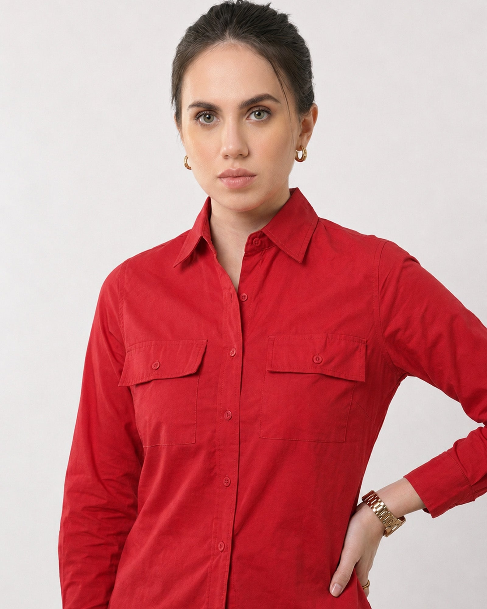 Close-up of Gracy scarlet red utility shirt dual chest pockets with curved button-down flaps