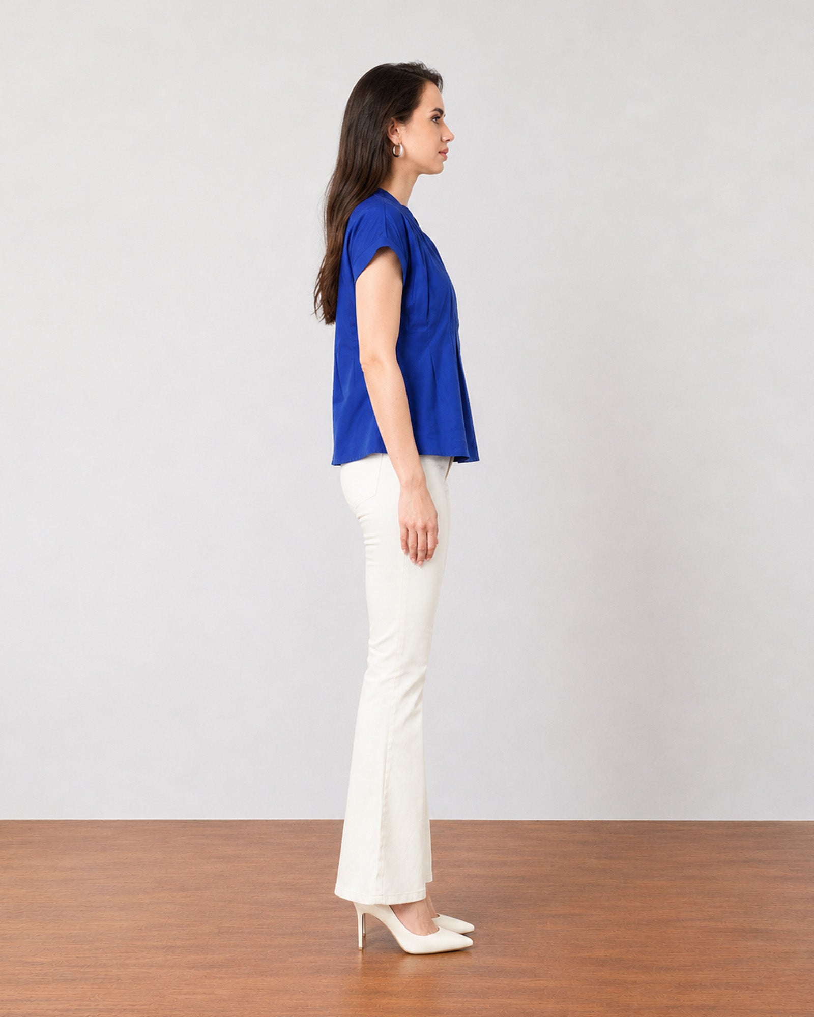 Greta royal blue office top with folded cuff sleeves, side profile view
