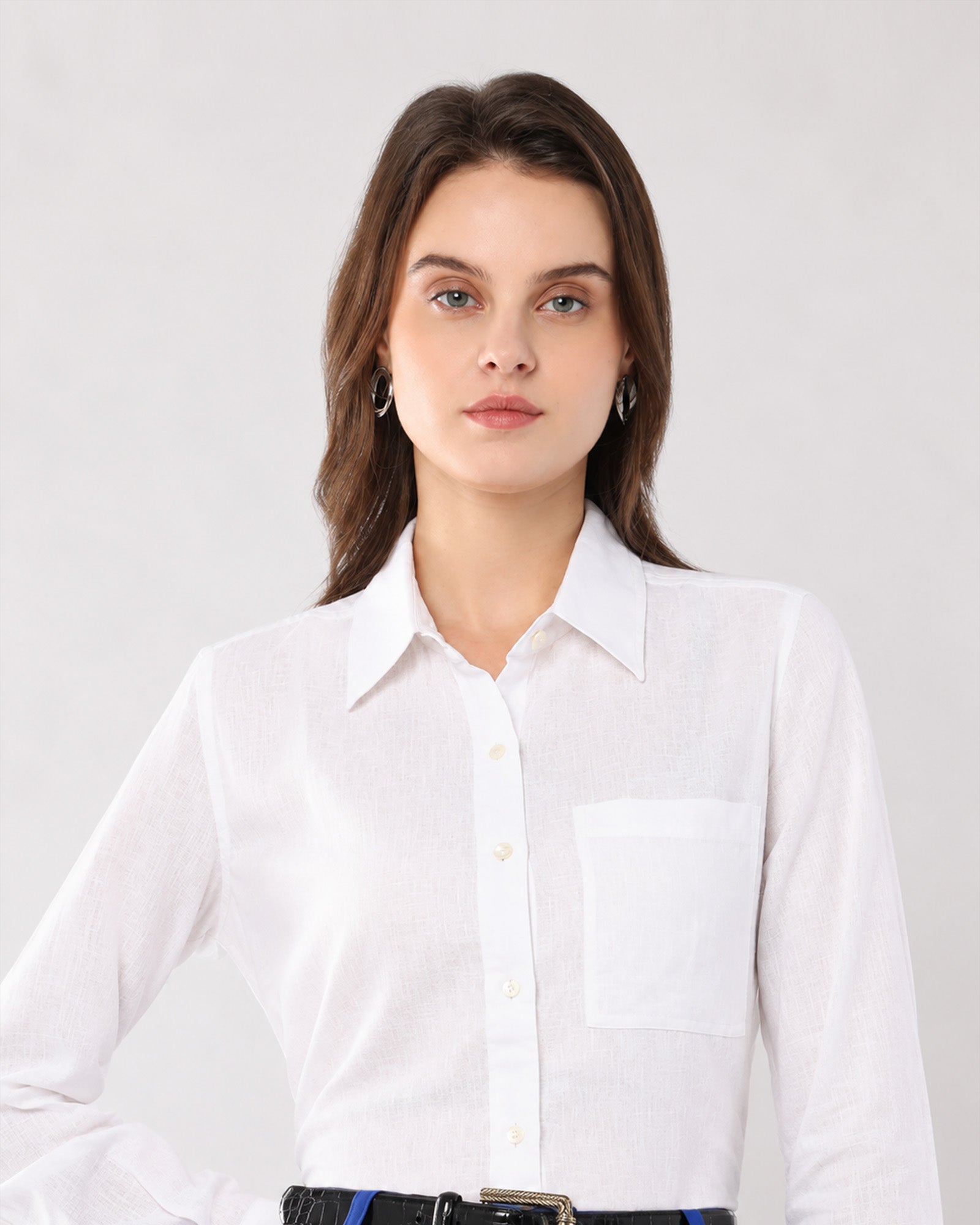 Close-up of Gwen white linen shirt pointed collar, button placket and single chest pocket