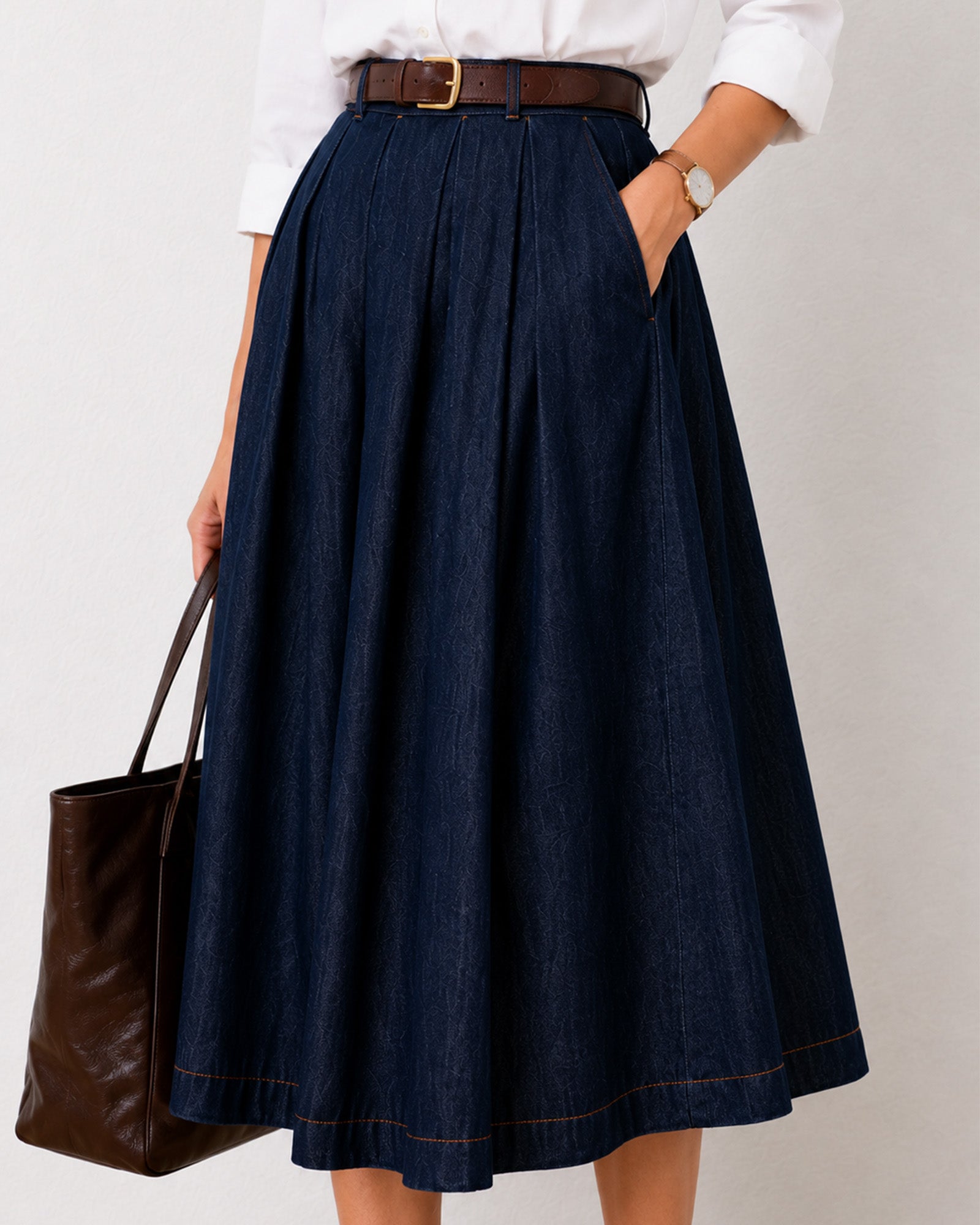 Close-up of Hansel indigo blue denim skirt front pleats and side pocket in 100% cotton
