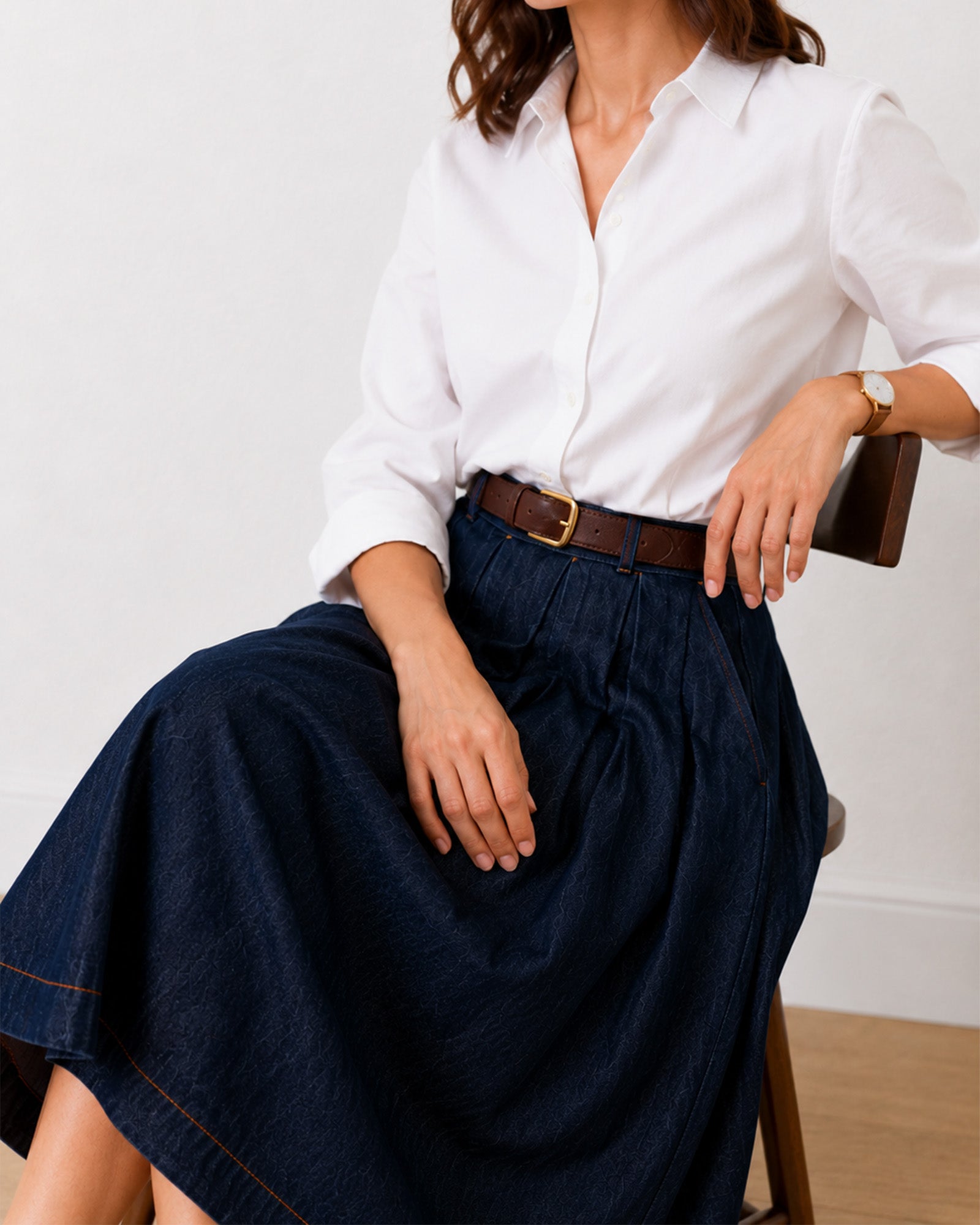 Hansel indigo blue denim skirt, seated view showing soft cotton pleat drape and high waist