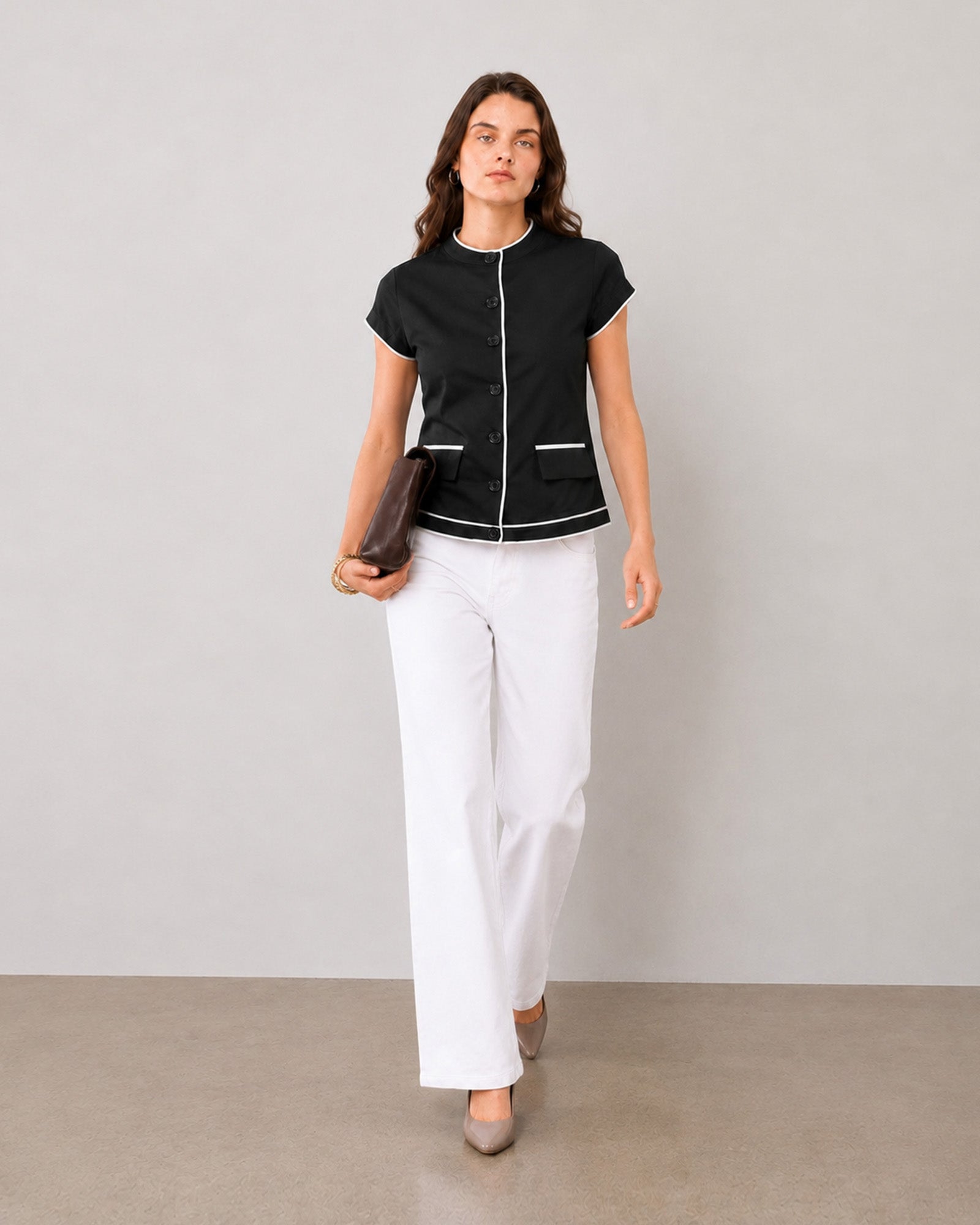 Harmony black and white piping formal top with flap pockets styled with white wide-leg trousers