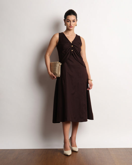 Hazel dark brown drapy dress styled with a clutch, full-length front view