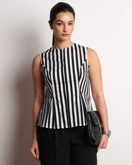 Hellen black and white pleated sleeveless top styled with a shoulder bag, front view