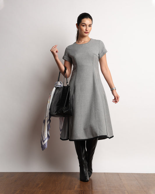 Hype dark grey drapy dress worn with knee boots, styled walking view