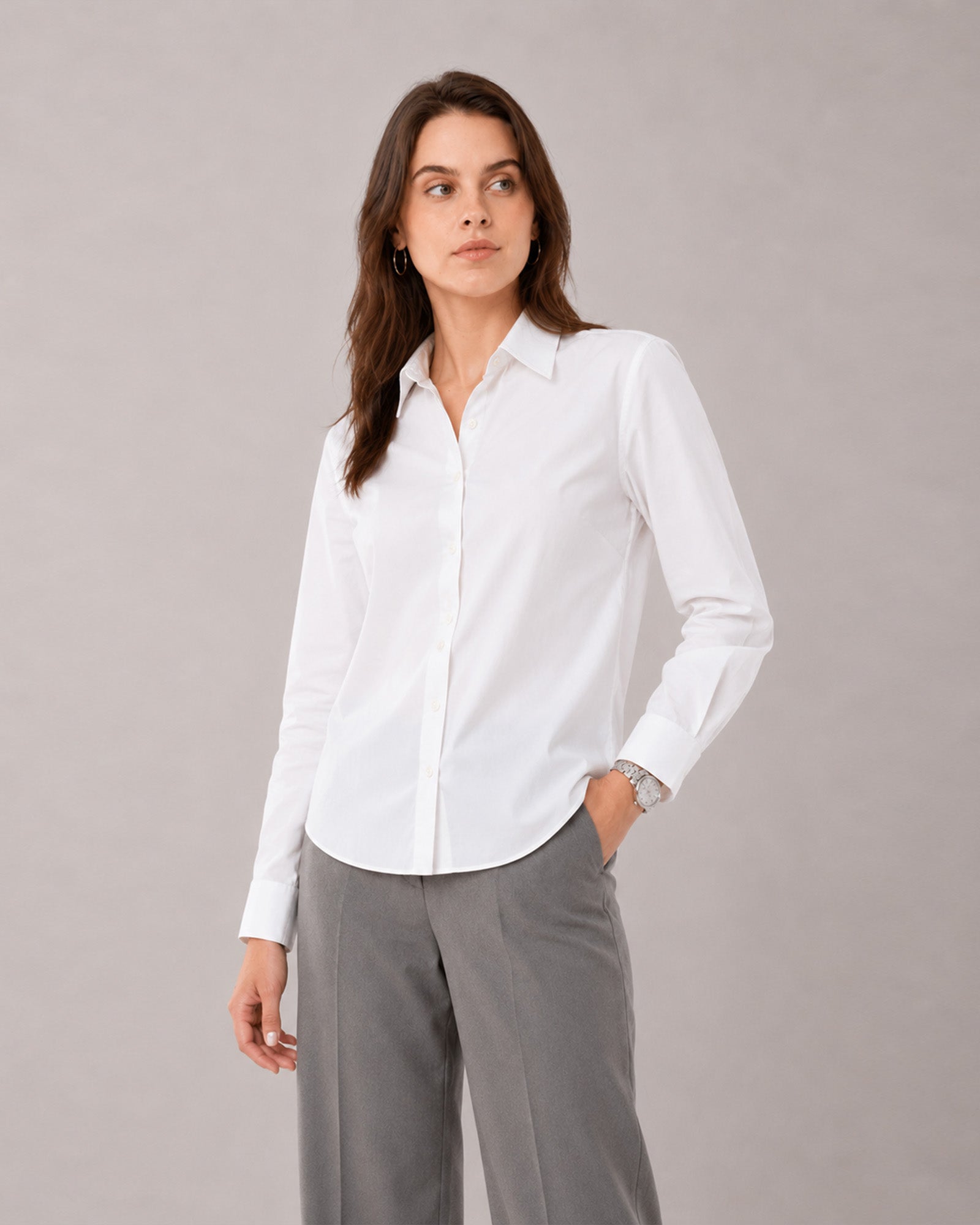 That white formal shirt with a curved hem and tailored buttoned cuffs, close-up view
