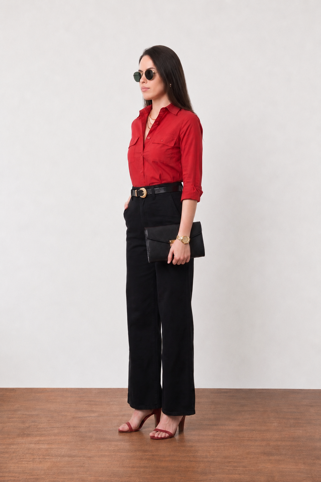 Gracy scarlet red utility shirt styled with a black belt and clutch, full-length angled view