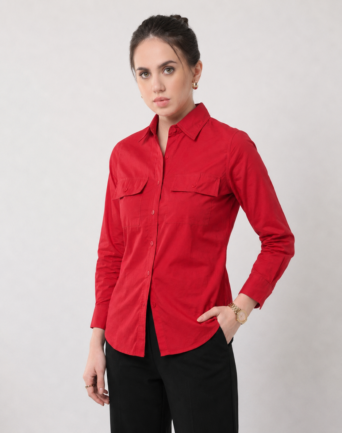 Gracy scarlet red utility shirt worn untucked, showing the curved hem and buttoned cuff