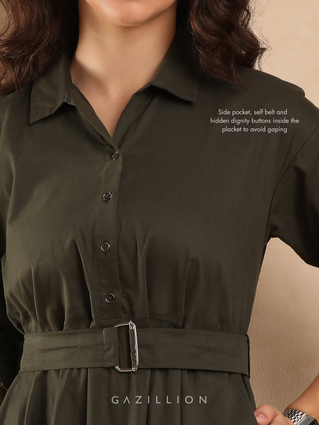 Green dress with Dignity buttons and a belt.