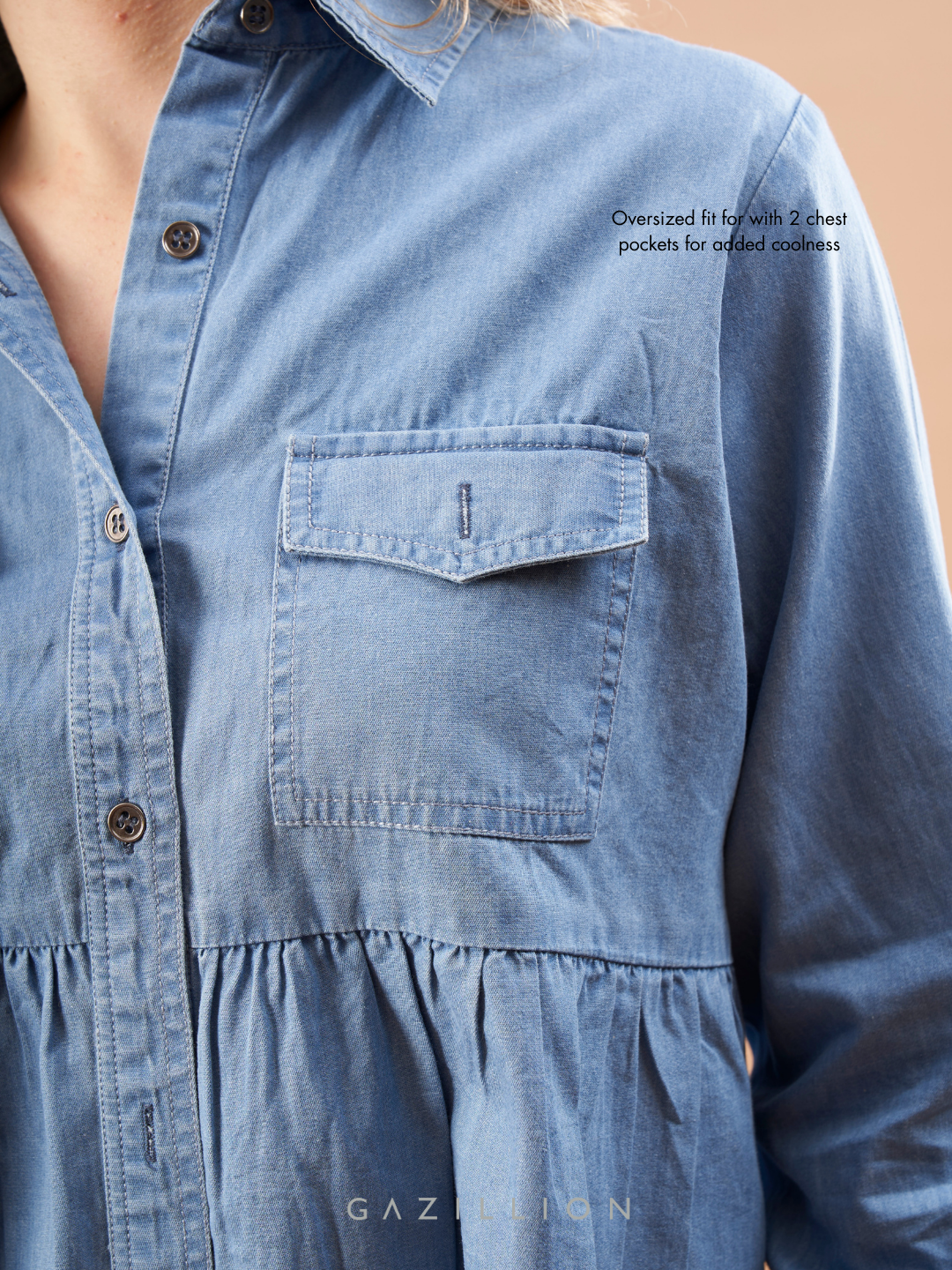 Close-up of a blue denim shirt on a beige background