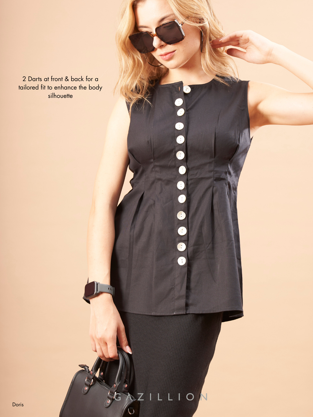 Woman wearing a black sleeveless top with buttons, holding sunglasses and a handbag on a beige background.